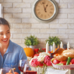 Joyful woman at a festive table with turkey and pumpkins, promoting Zing Plumbing's garbage disposal tips.