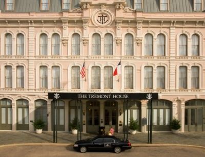 The Tremont House hotel in Boston, showcasing its historic facade with American and French flags, symbolizing early American hospitality and the introduction of indoor plumbing.