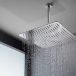 Modern rain showerhead in a minimalist bathroom designed by Zing Plumbing for a spa-like experience.