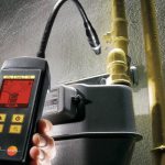 Handheld digital inspection tool with flexible camera head assessing plumbing pipe fittings for Zing Plumbing services.