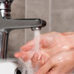 Hands under a faucet washing with flowing water, emphasizing cleanliness for proactive plumbing maintenance by Zing Plumbing.