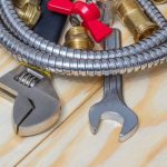 Various plumbing tools, like adjustable and open-end wrenches, for Zing Plumbing maintenance services in Tucson, AZ.
